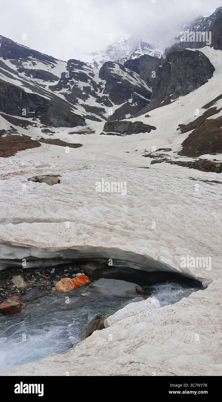 adventure travel in himalaya mountains, high altitude alpine valley covered with glacier at marhi near rohtang pass, manali, himachal pradesh, india Stock Photo