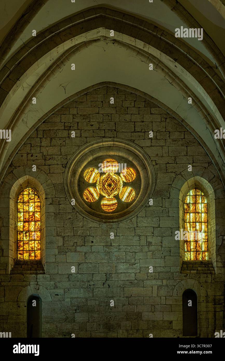 The windows and the medieval rose window closed by alabaster slabs in the Cistercian abbey of Casamari. Veroli, province of Frosinone, Lazio, Italy, Stock Photo