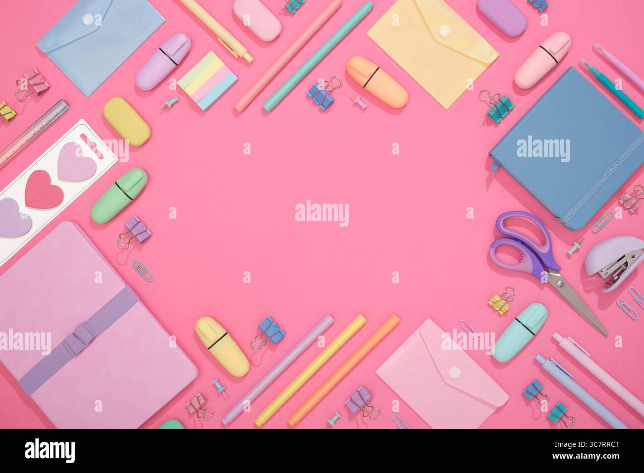 Frame of colorful school and office stationery set on pink background. Flatly, copyspace Stock Photo
