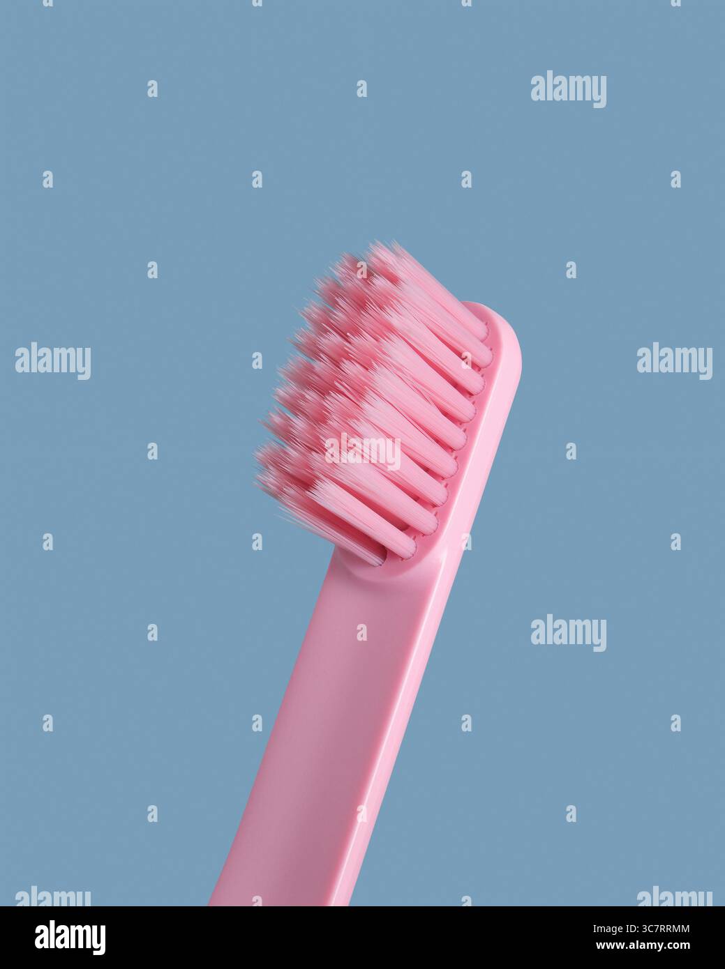 Pink toothbrush on blue background. Closeup Stock Photo