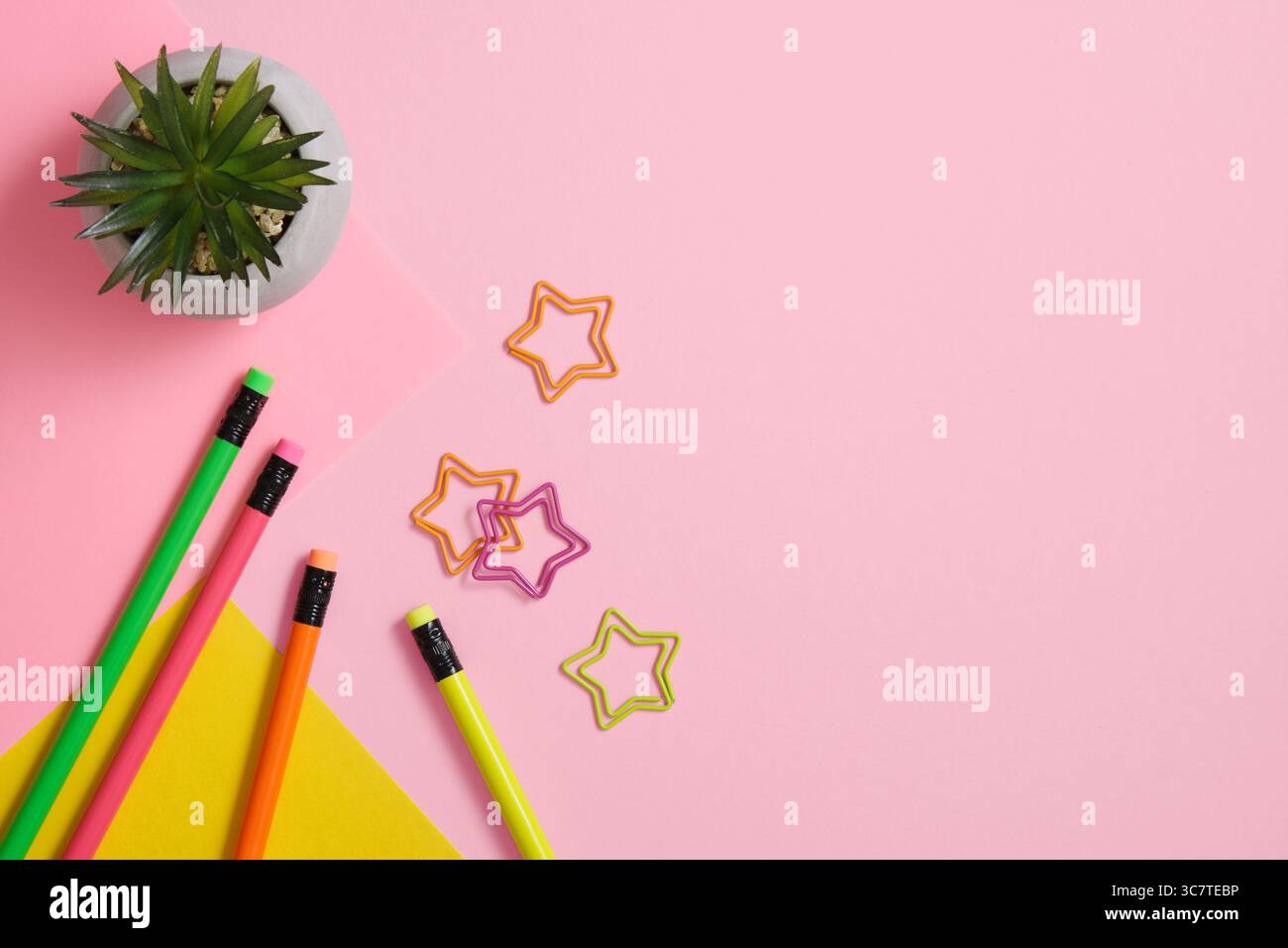 Pencils and paper clips on a roh and yellow background. A place for your text. Stock Photo