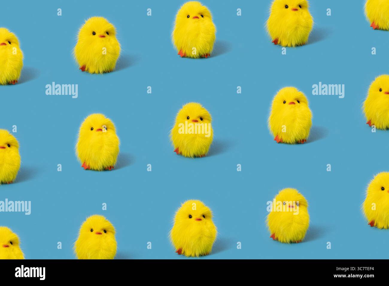 Funny yellow toy chicks on blue background, isometric pattern Stock Photo