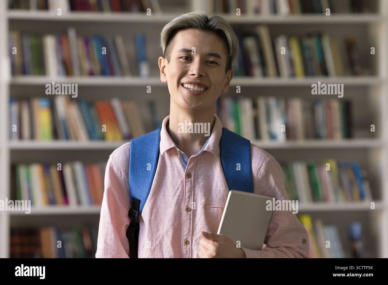 Portrait smiling student guy holding digital tablet looking at camera Stock Photo