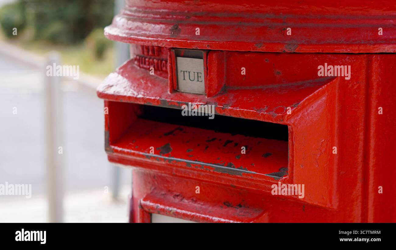 Close up of iconic red British mailbox used for traditional UK postal ...