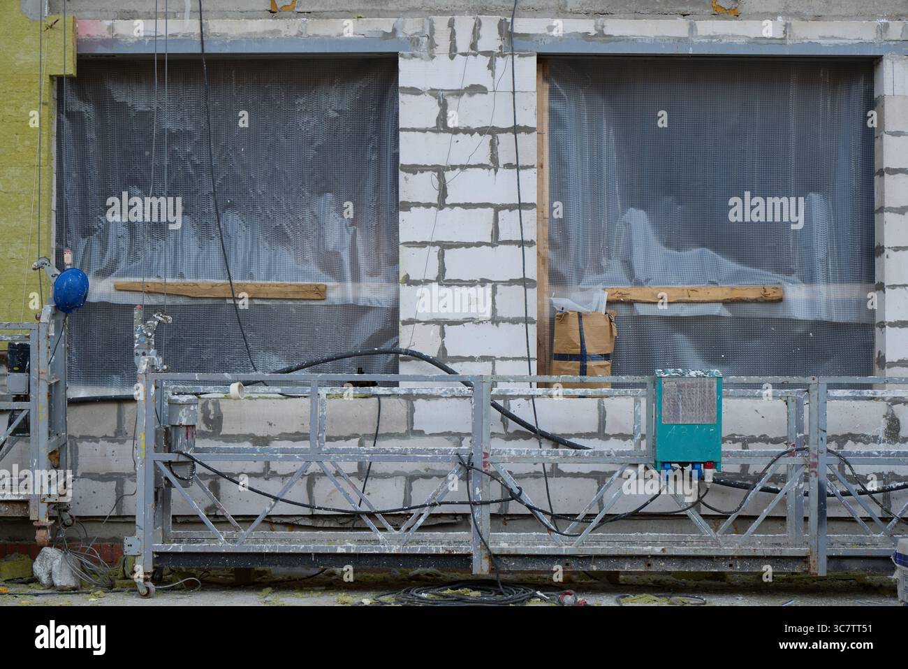 A Construction Site Featuring Unfinished Windows and Scaffolding Elements Awaiting Completion Stock Photo