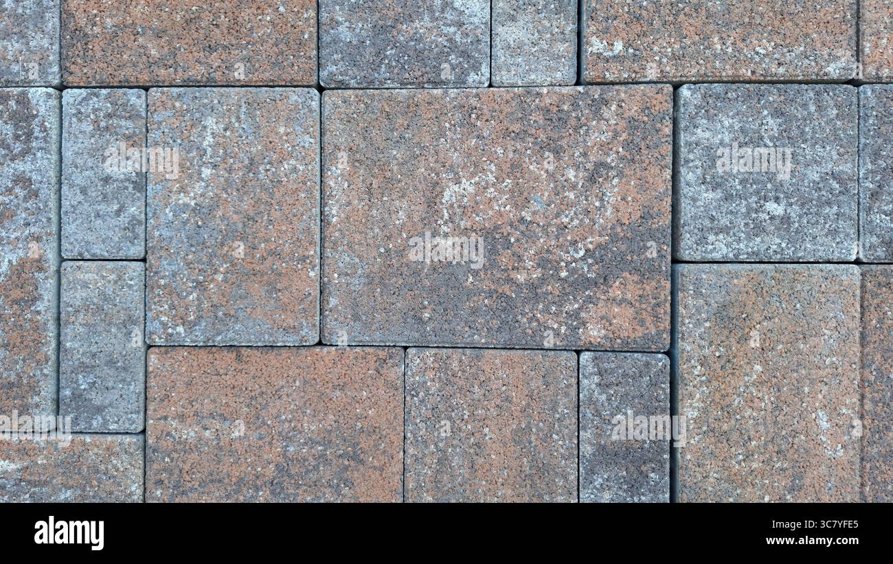 Patterned brick pavement with rustic textured stones in earthy tones Stock Photo