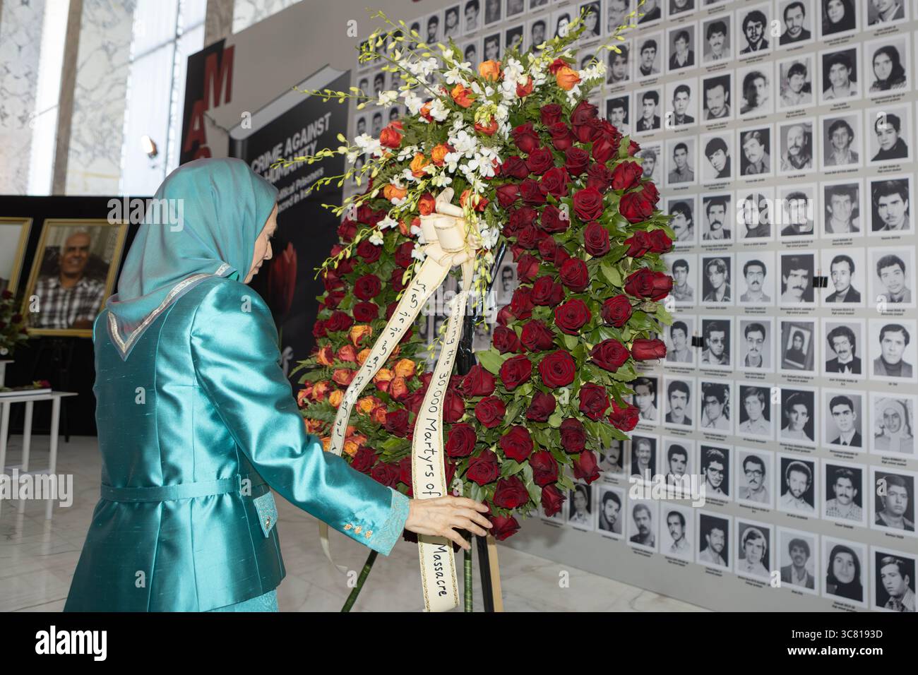 Maryam Rajavi is seen placing a floral wreath honoring the 30,000 ...