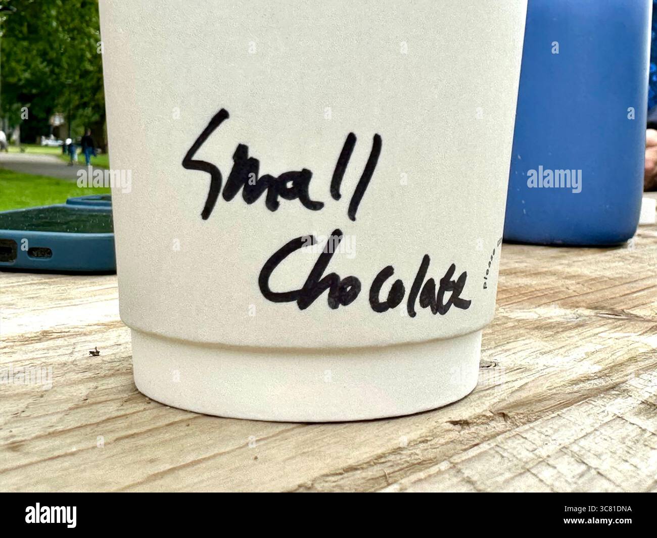 The bottom of a paper cup with the words Small Chocolate written on it - Smartphone Captured Stock Image