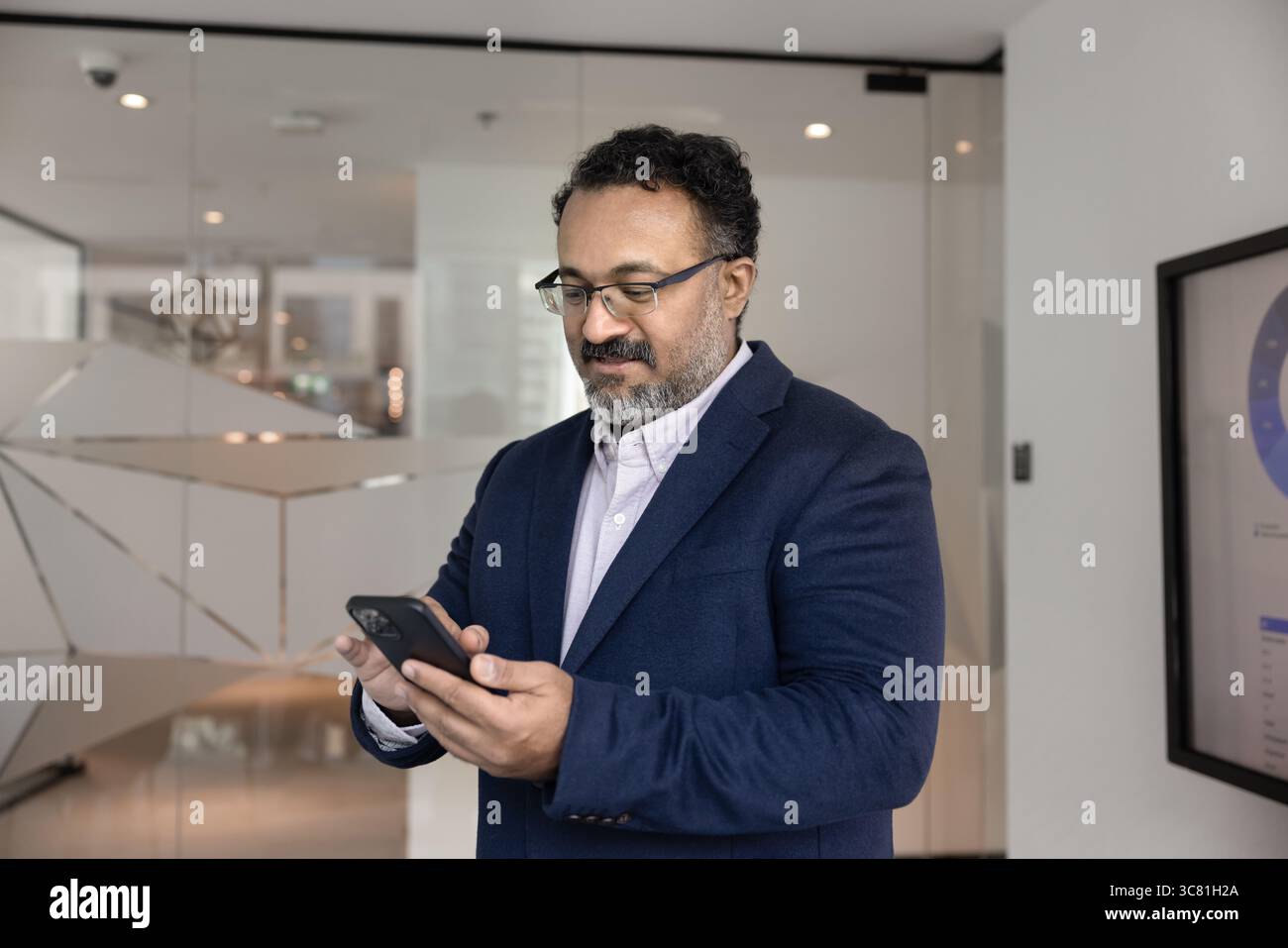 Mature businessman senior executive text messages using app on cell Stock Photo
