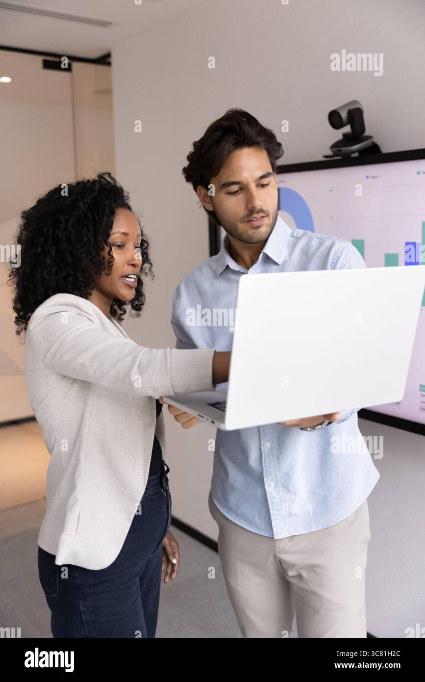 Business team two diverse managers collaborating on project on notebook Stock Photo