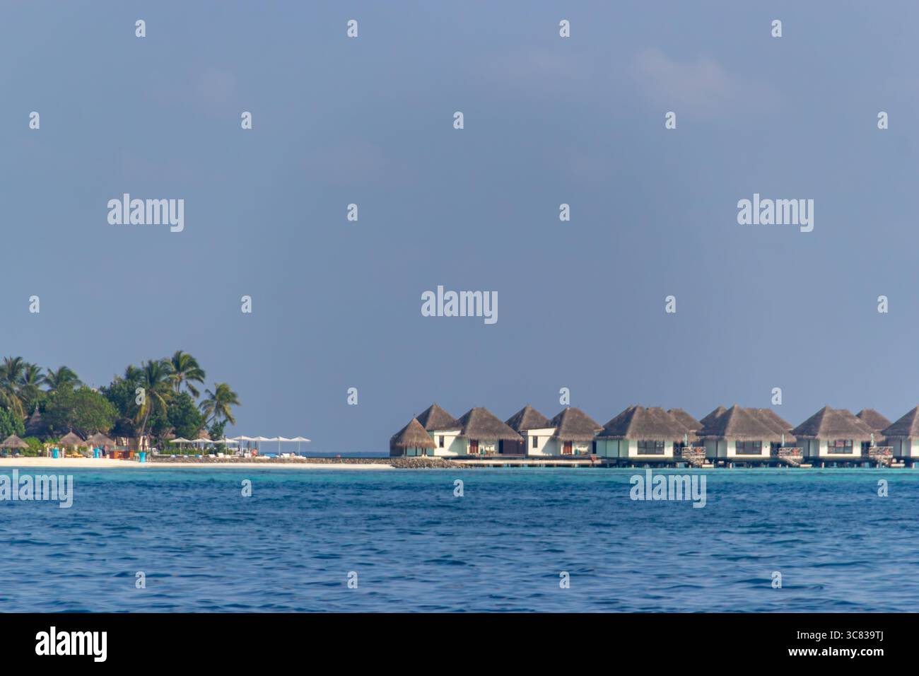 Overwater bungalows provide luxurious island retreat Stock Photo - Alamy
