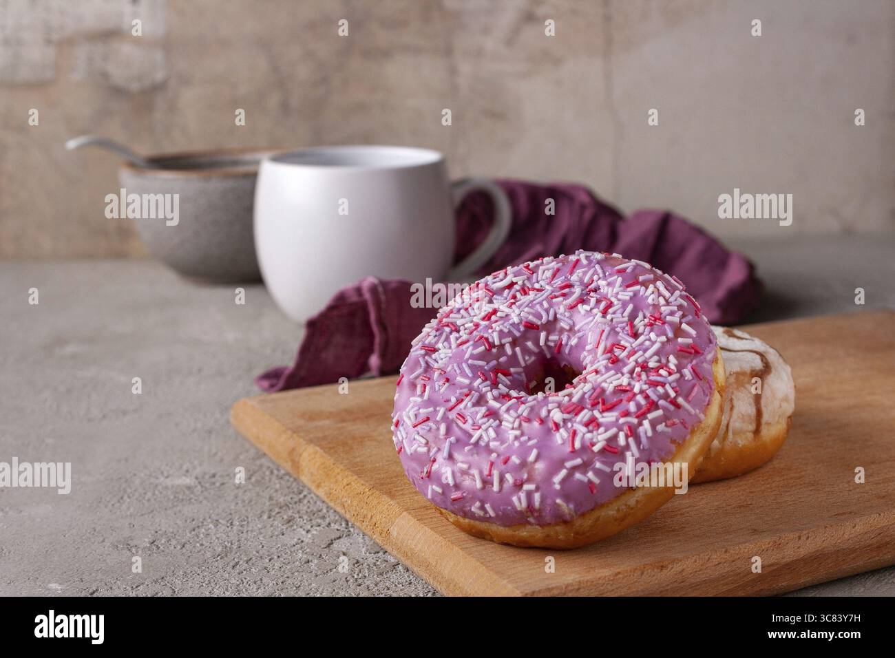Pink and white donuts on a wooden board, place for text Stock Photo