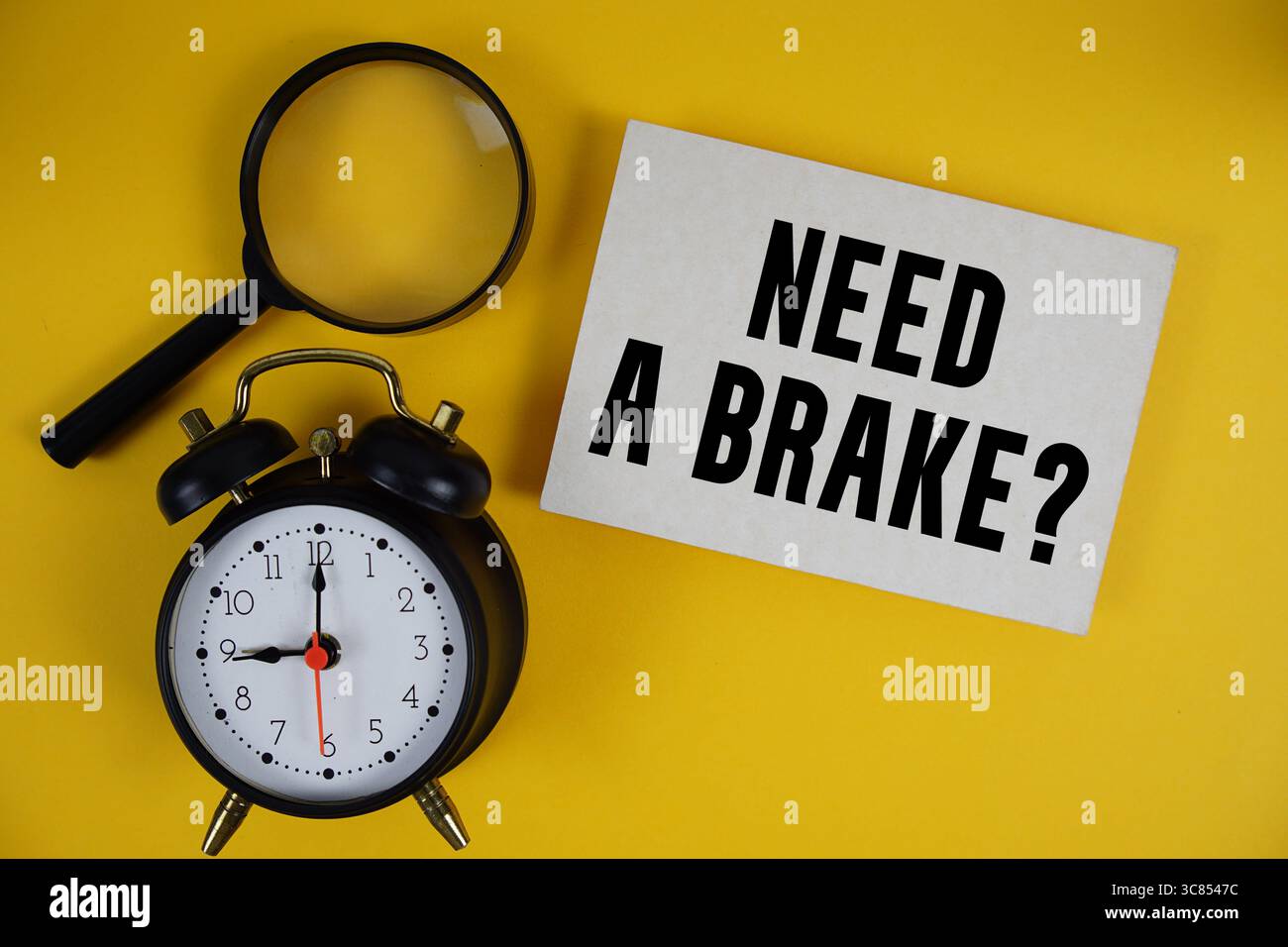Need a Brake? text written on paper with magnifying glass and alarm clock on yellow background Stock Photo