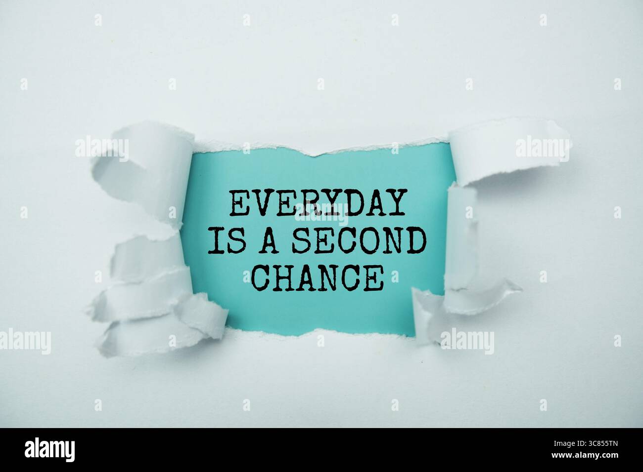 Everyday Is A Second Chance message written on blue paper with torn paper background Stock Photo