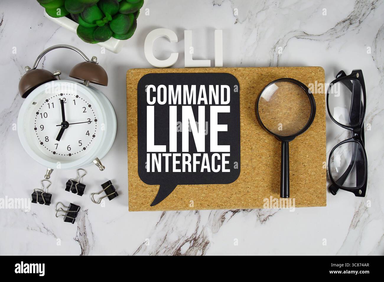 CLI Command Line Interface text with alarm clock and magnifying glass on marble background Stock Photo