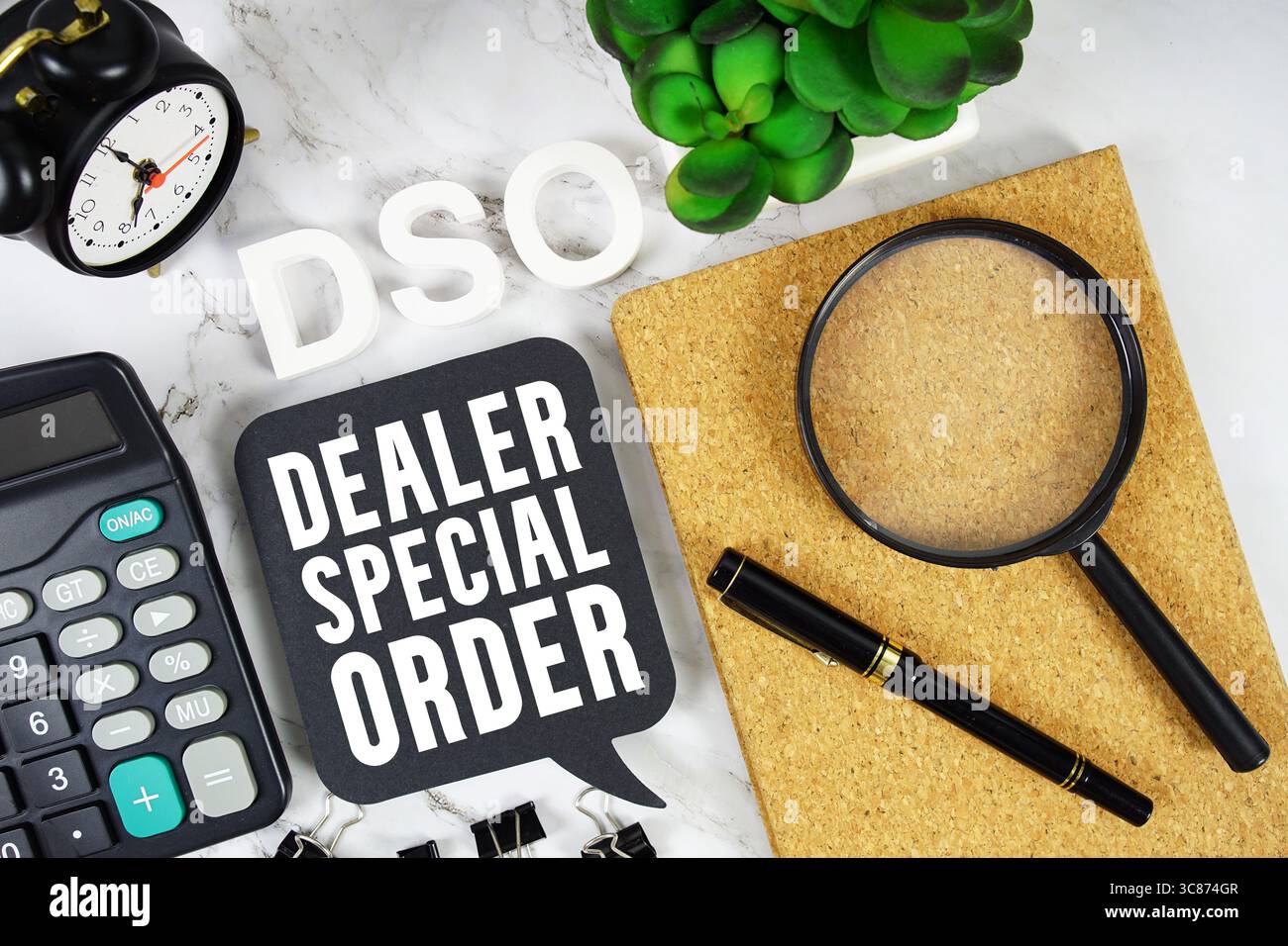 DSO Dealer Special Order text with Calculator, alarm clock and magnifying glass on marble background Stock Photo