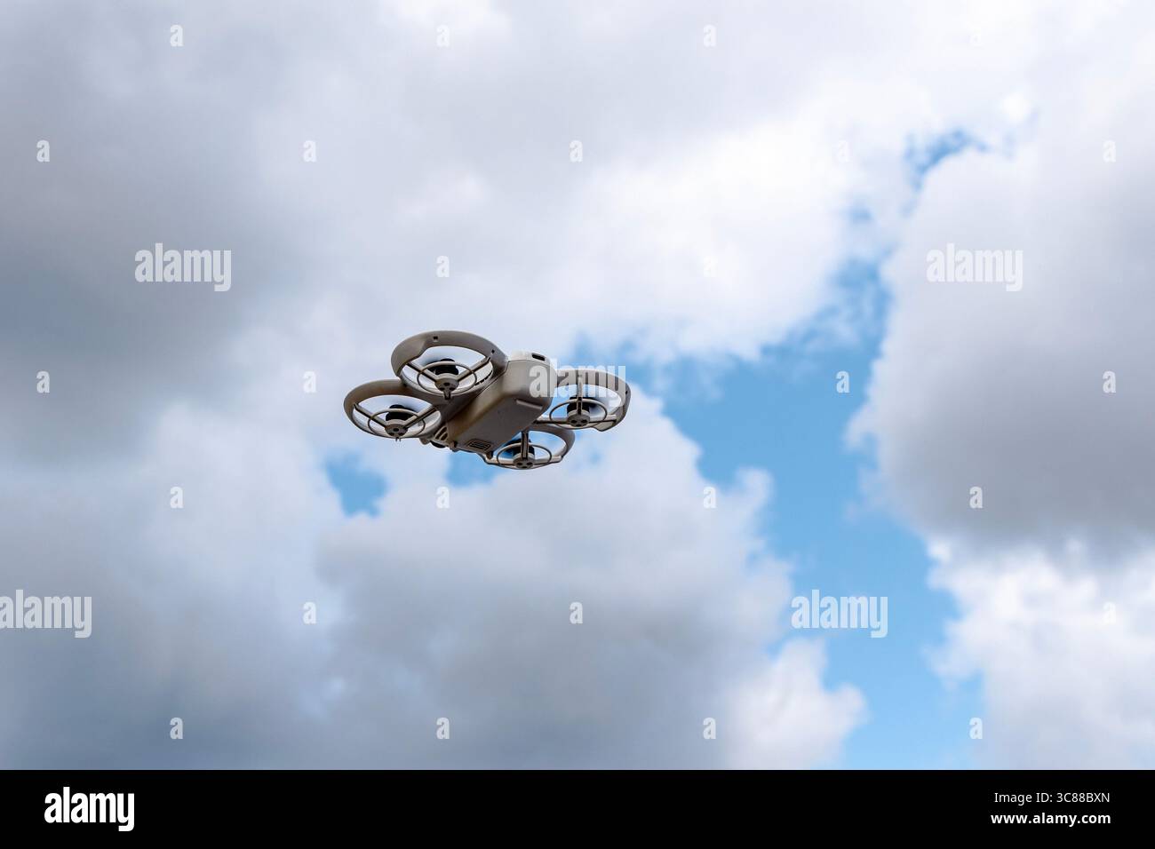 A portable photography drone flying in the sky Stock Photo