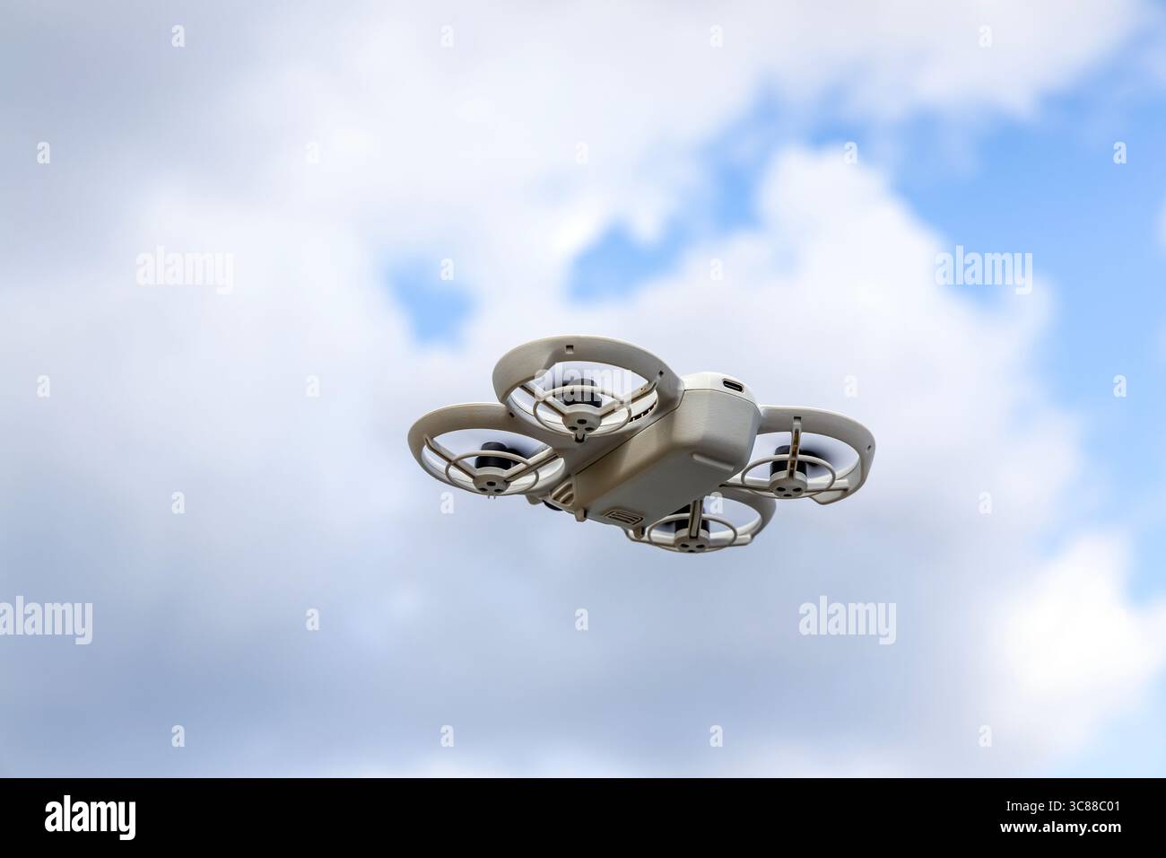 A portable photography drone flying in the sky Stock Photo