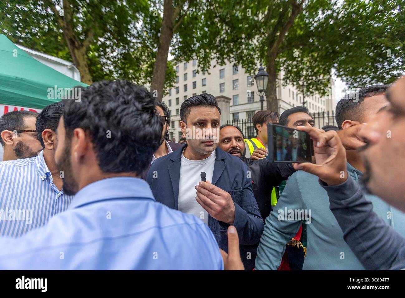 LONDON, UK – 3 August 2025 Supporters of Pakistan Tehreek-e-Insaf (PTI) gathered outside 10 Downing Street in London for the only PTI protest held in the UK that day. Organised by the PTI London Dream Team, the demonstration called for the immediate release of former Prime Minister Imran Khan and denounced ongoing political repression in Pakistan. Protesters urged the UK government and international community to speak out in support of democracy and human rights. In attendance Sayed Zulfikar Abbas Bukhari, also known as Zulfi Bukhari, is a UK-based Pakistani politician, businessman and film pr Stock Photo