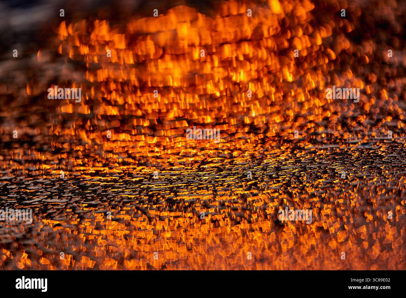 Gilded Ripples Dance Upon Molten Waters Stock Photo