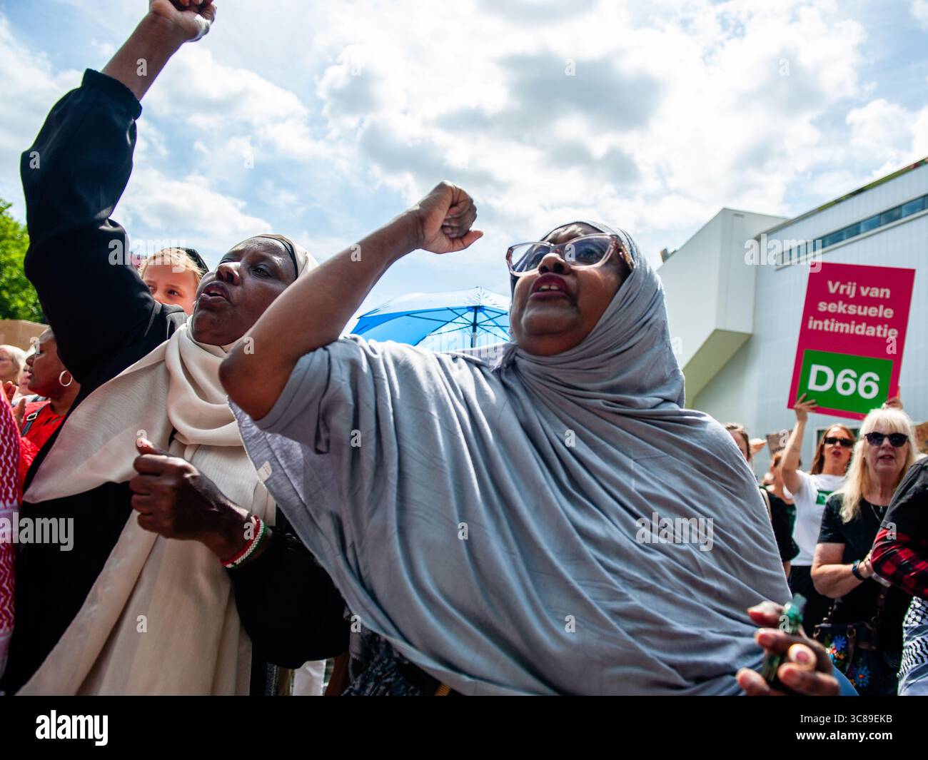 Muslim protesters chant slogans against femicide during a demonstration against femicide in Rotterdam. The Dutch feminist organization 'Dolle Mina' held a national protest march against femicide in Rotterdam. This is in response to two murders of women in less than a week. In both cases, the suspect turned out to be a (former) partner of the victim.'Dolle Mina' demands that femicide must be recognized as a 'specific and structural form of gender-based violence.' During the speech of one of the parents of one of the victims, a man ran onto the stage and tried to disrupt the event. Stock Photo