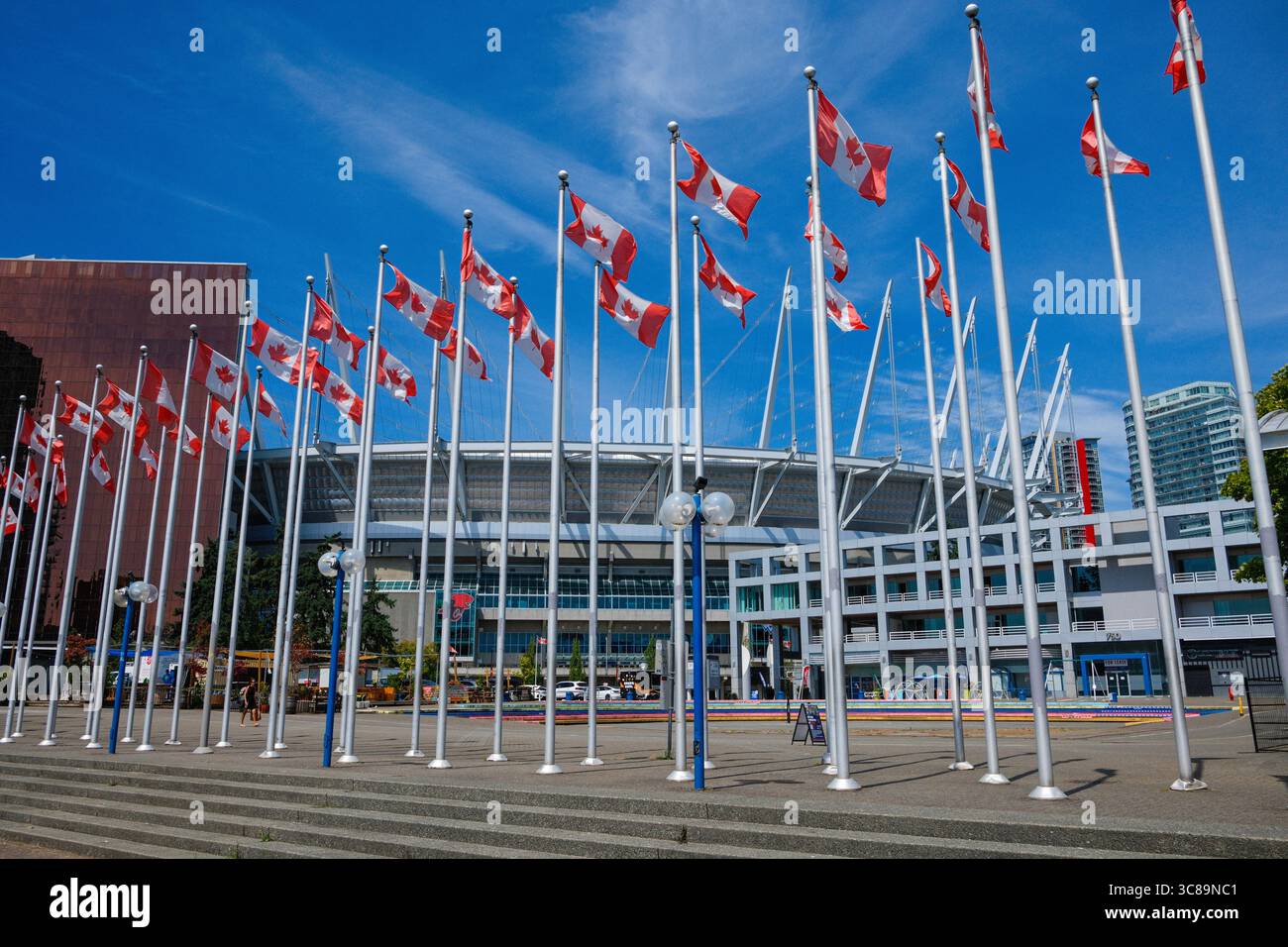 BC Place Stadium behind a row of Canadian flags at the Plaza of Nations, Vancouver, BC. Stock Photo