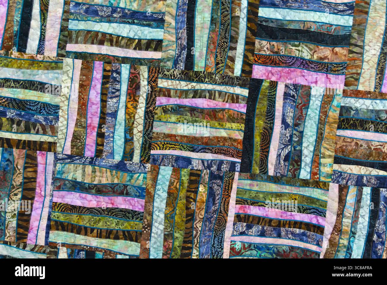 A patchwork quilt with many different colored squares. Abstract background Stock Photo