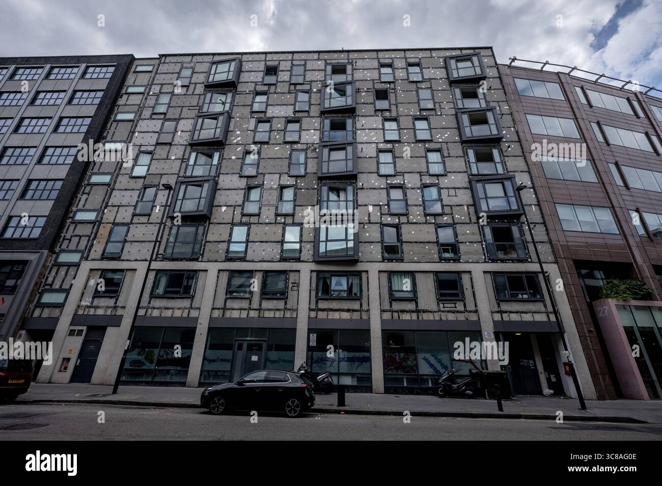 London, UK. 2nd August, 2025. Exterior building cladding is completely removed from residential flat building on Goswell road. Stock Photo