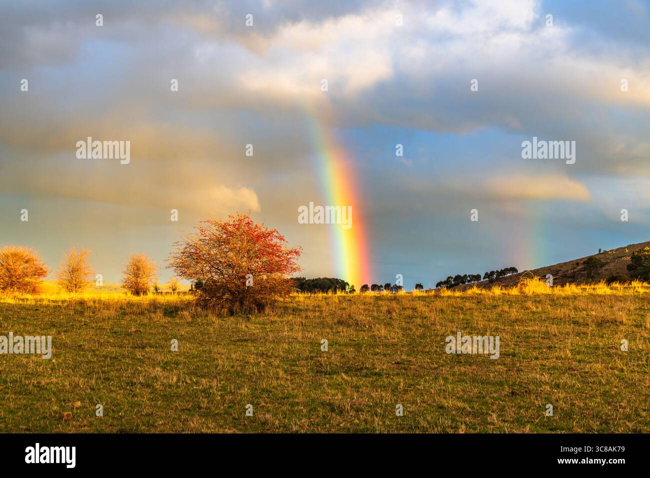 Rainbow over the countryside at Blayney in the Central West of NSW, Australia. Stock Photo