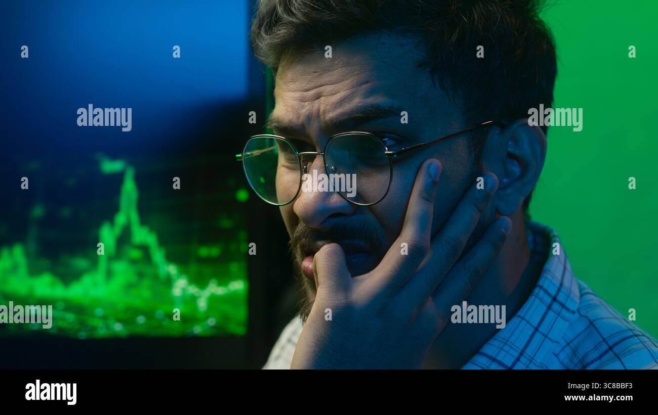Close up face nervous Arabian Indian man looking computer monitor data ...