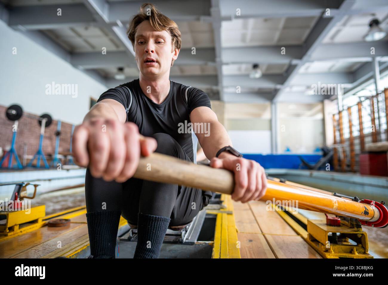 Dedicated male rowing crew practices synchronization, paddling ...