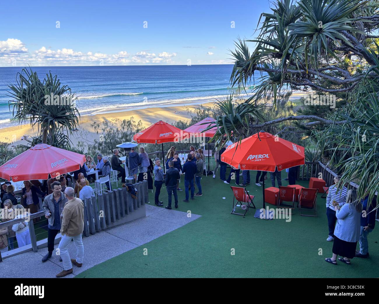 People on function lawn overlooking beach, Sunshine Beach Surf Club, near Noosa, Sunshine Coast, Queensland, Australia. No MR Stock Photo