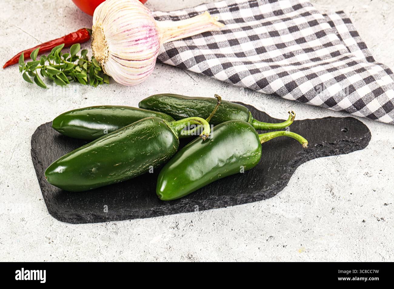 Mexican hot green Jalapeno pepper on the board Stock Photo - Alamy