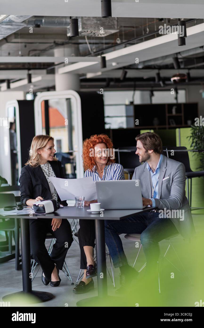 Creative team having discussion over coffee about project strategy. Stock Photo