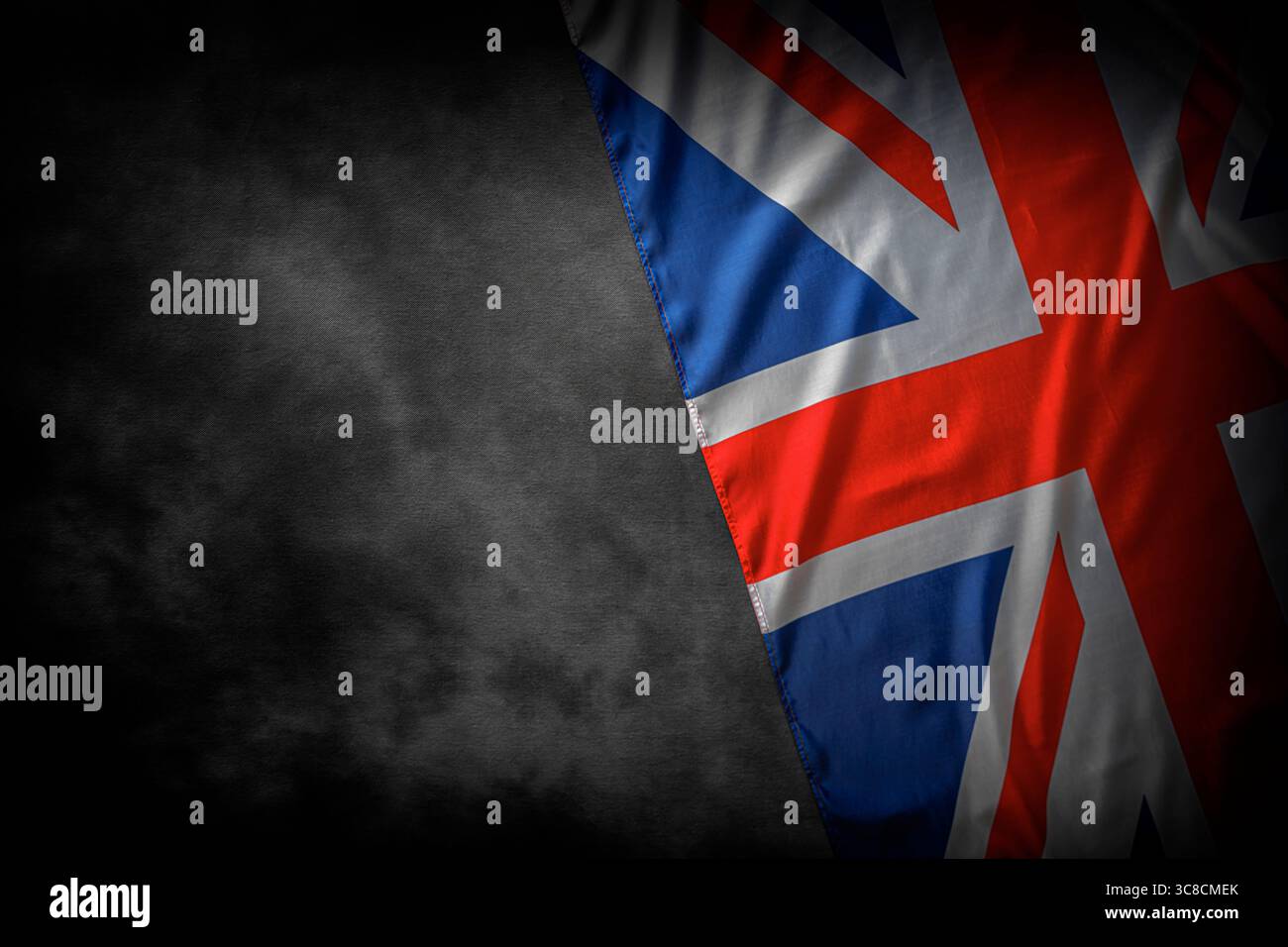Union Jack flag of the United Kingdom with dramatic lighting and dark background Stock Photo