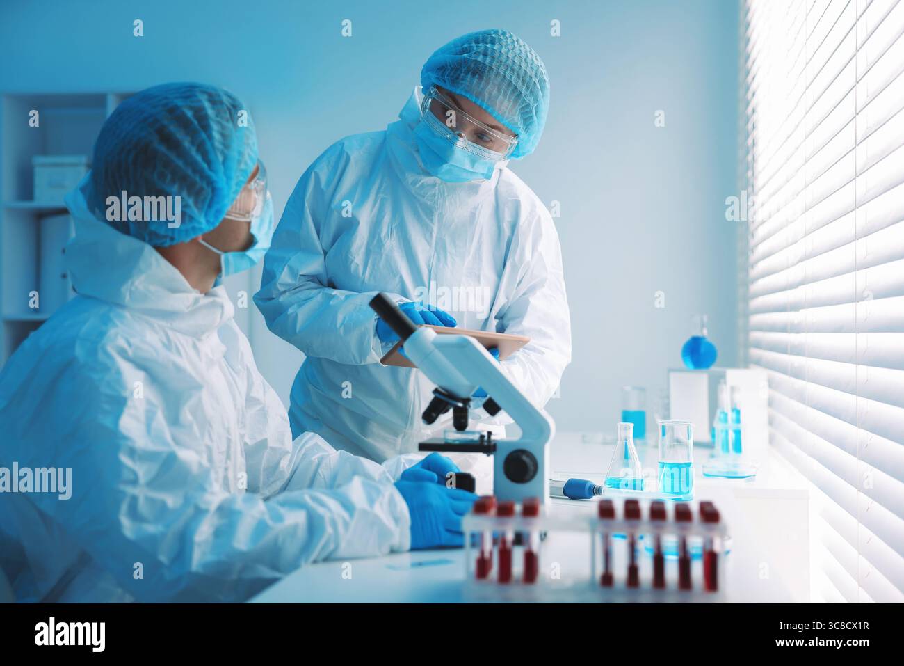 Medical analysis. Two Scientists working in laboratory Stock Photo - Alamy