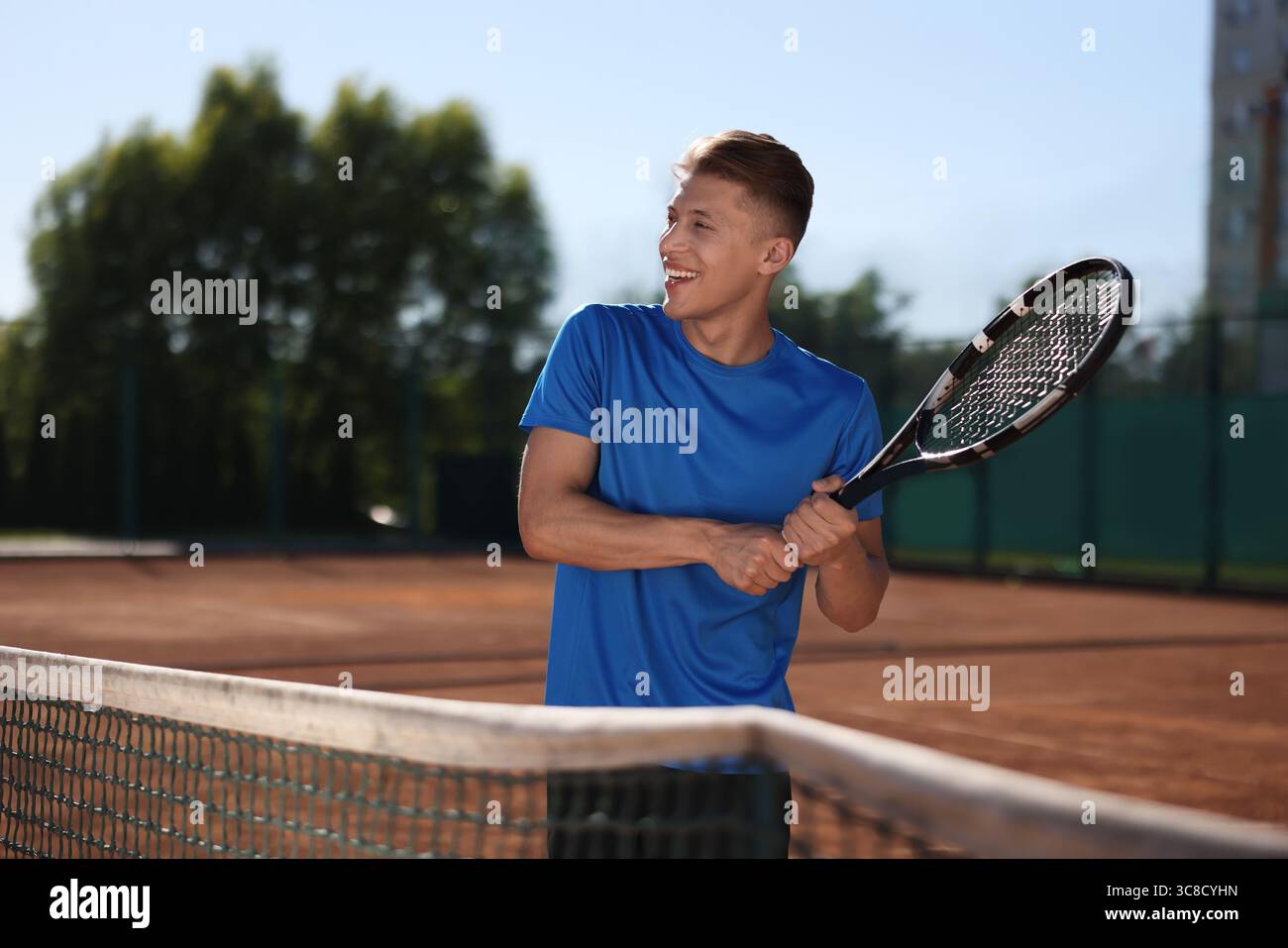Man With Racket Young man with racket playing tennis at court. Space for text Stock ...