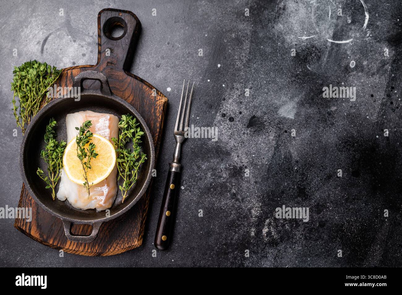 Raw cod fish fillets, whitefish without skin in skillet. black ...