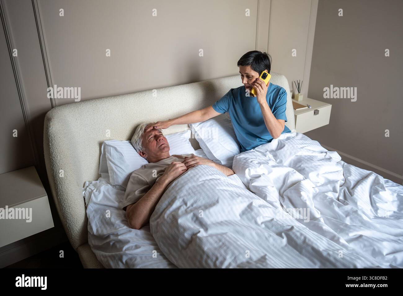Sick Partner Concerned woman check temperature of sick partner in bed while ...