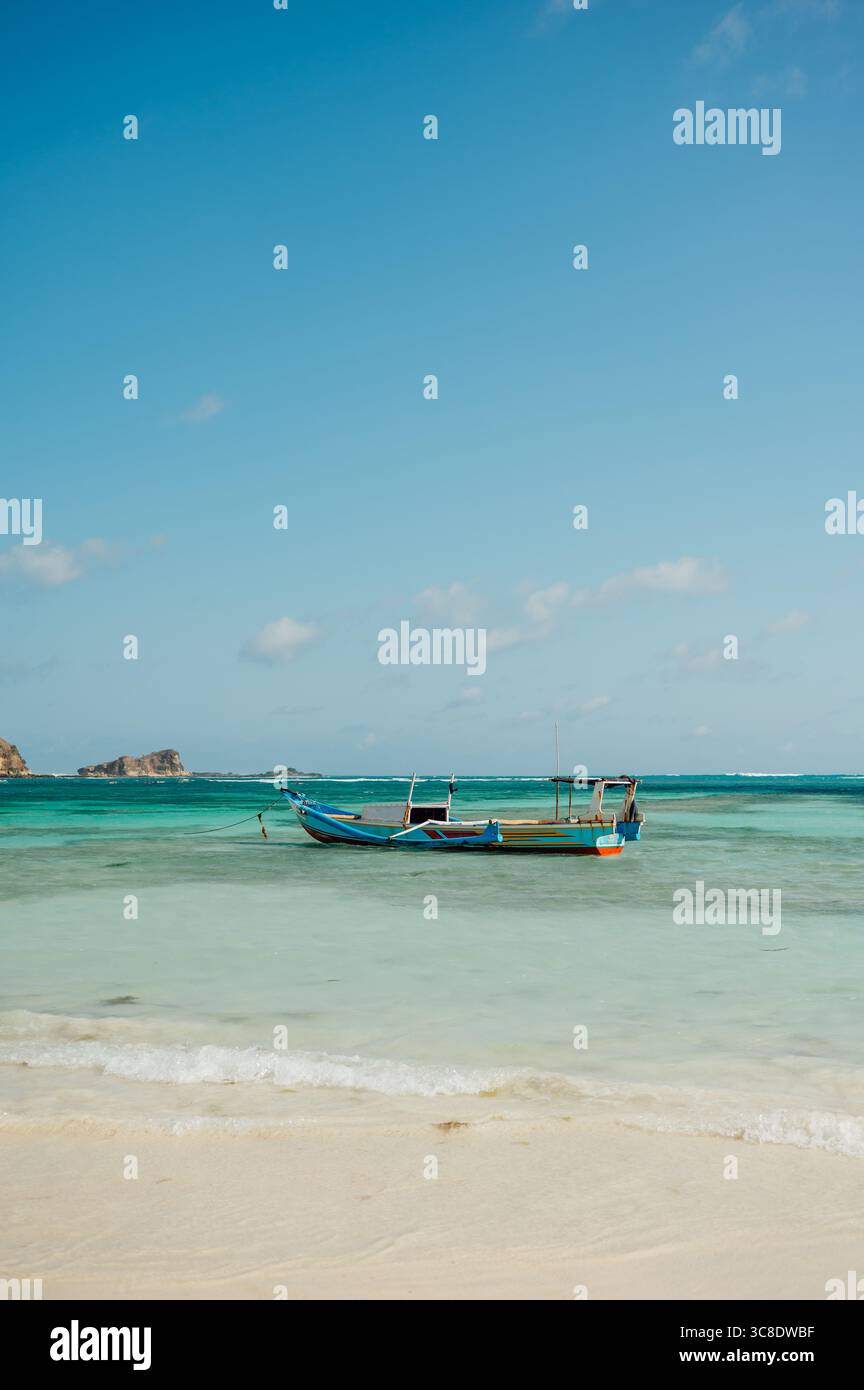 Fishing Boat on Turquoise Water at Tanjung Aan Beach, Lombok Stock Photo