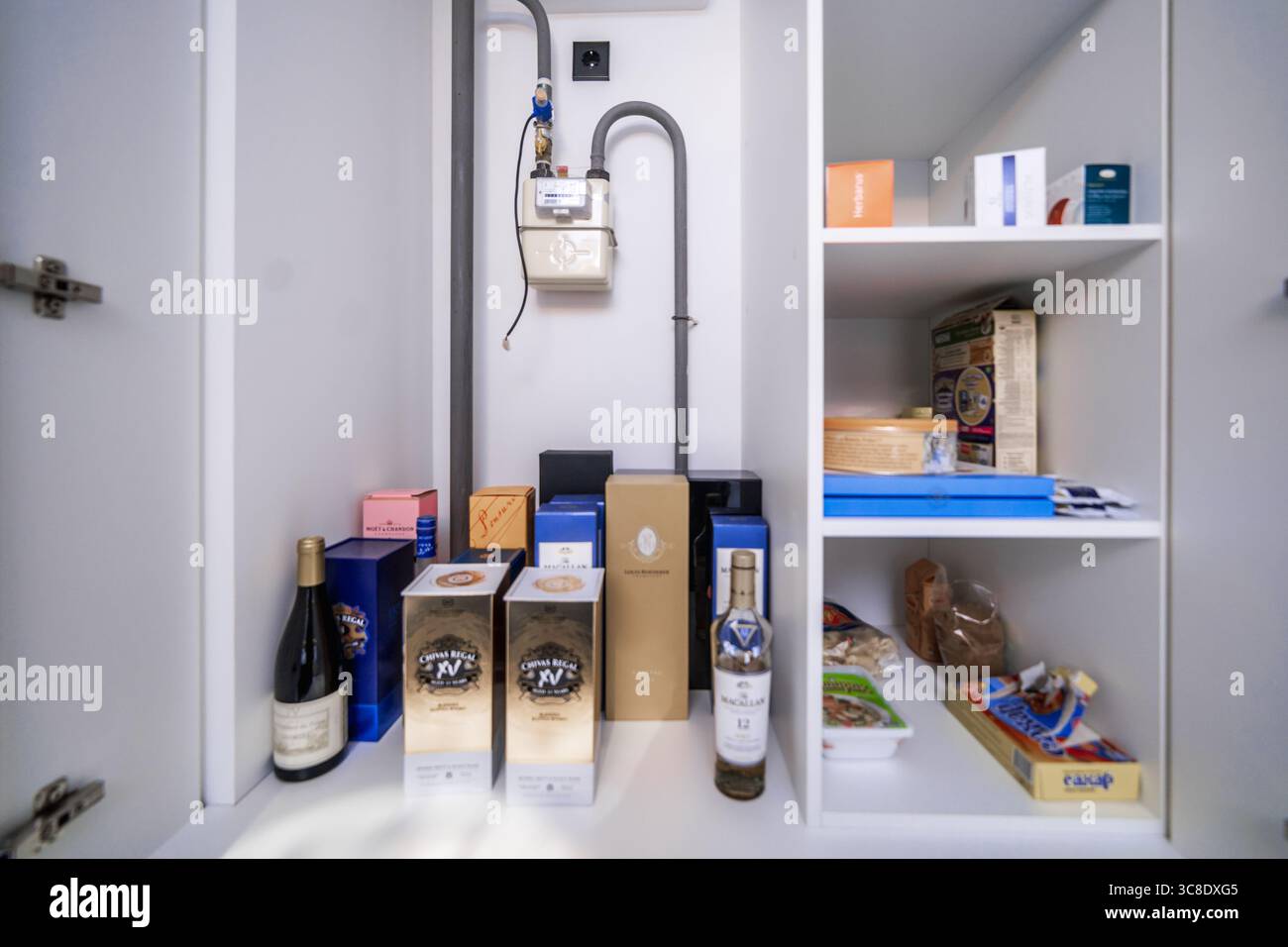 Open cabinets in a new kitchen set. Almost empty shelves. Stock Photo