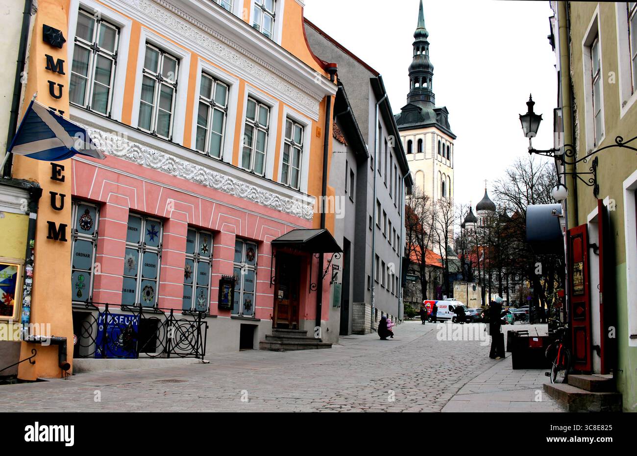 View through the colourful streets of Tallinn, Estonia, to the spire of St. Nicholas Church. Stock Photo