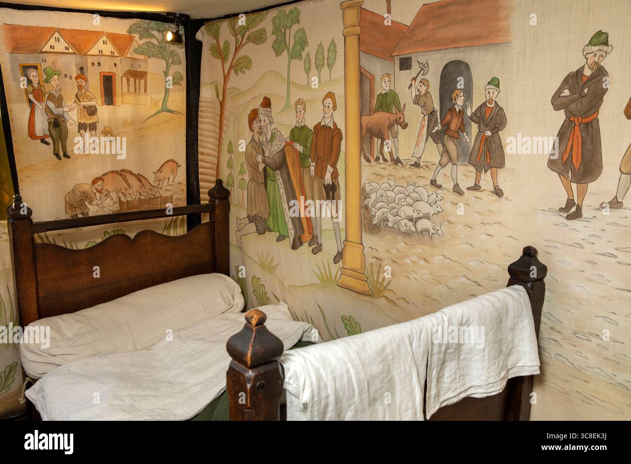 UK, Herefordshire, Hereford, High Town, Black and White House Museum interior, top floor bedroom with painted wall hangings Stock Photo