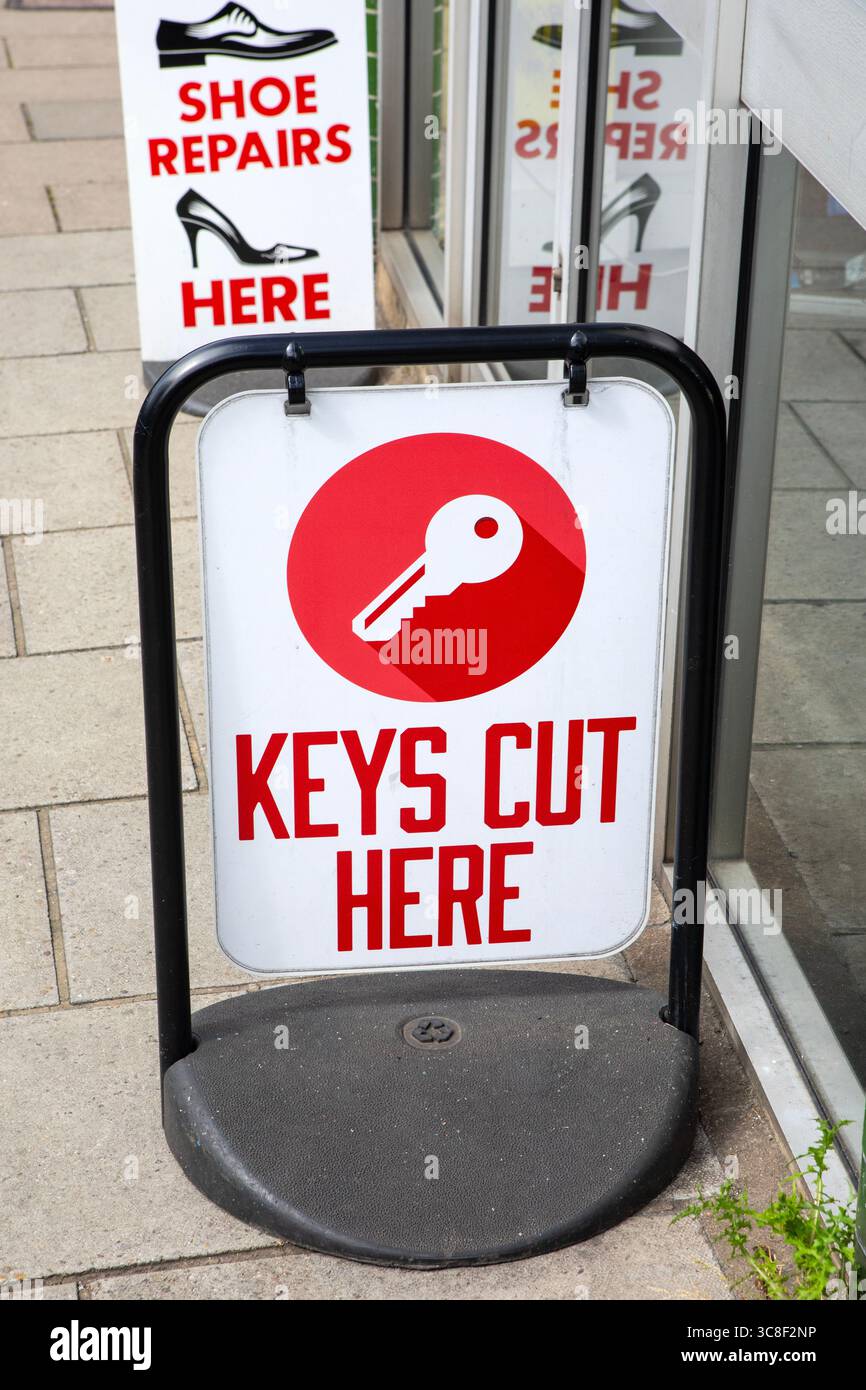 A Keys Cut Here sign outside a shop Stock Photo - Alamy