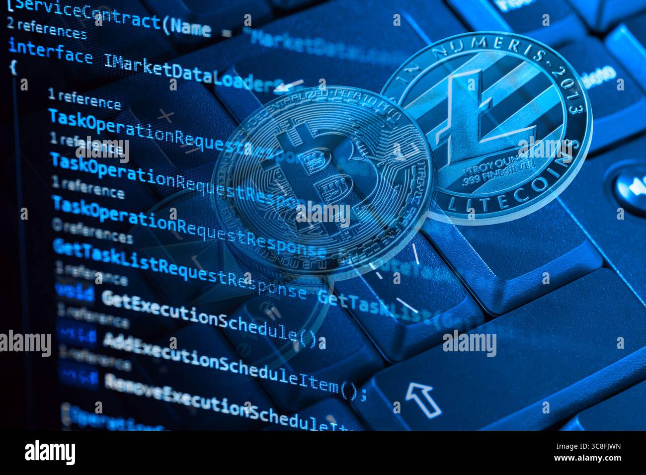 Information technology concept. Coding programmer language script text on screen monitor display with a PC keyboard and bitcoin, ethereum and litecoin Stock Photo