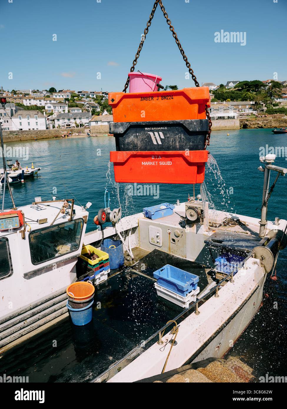 A fishing boat unloading its fresh catch in St Mawes, Falmouth, Cornwall England UK Stock Photo
