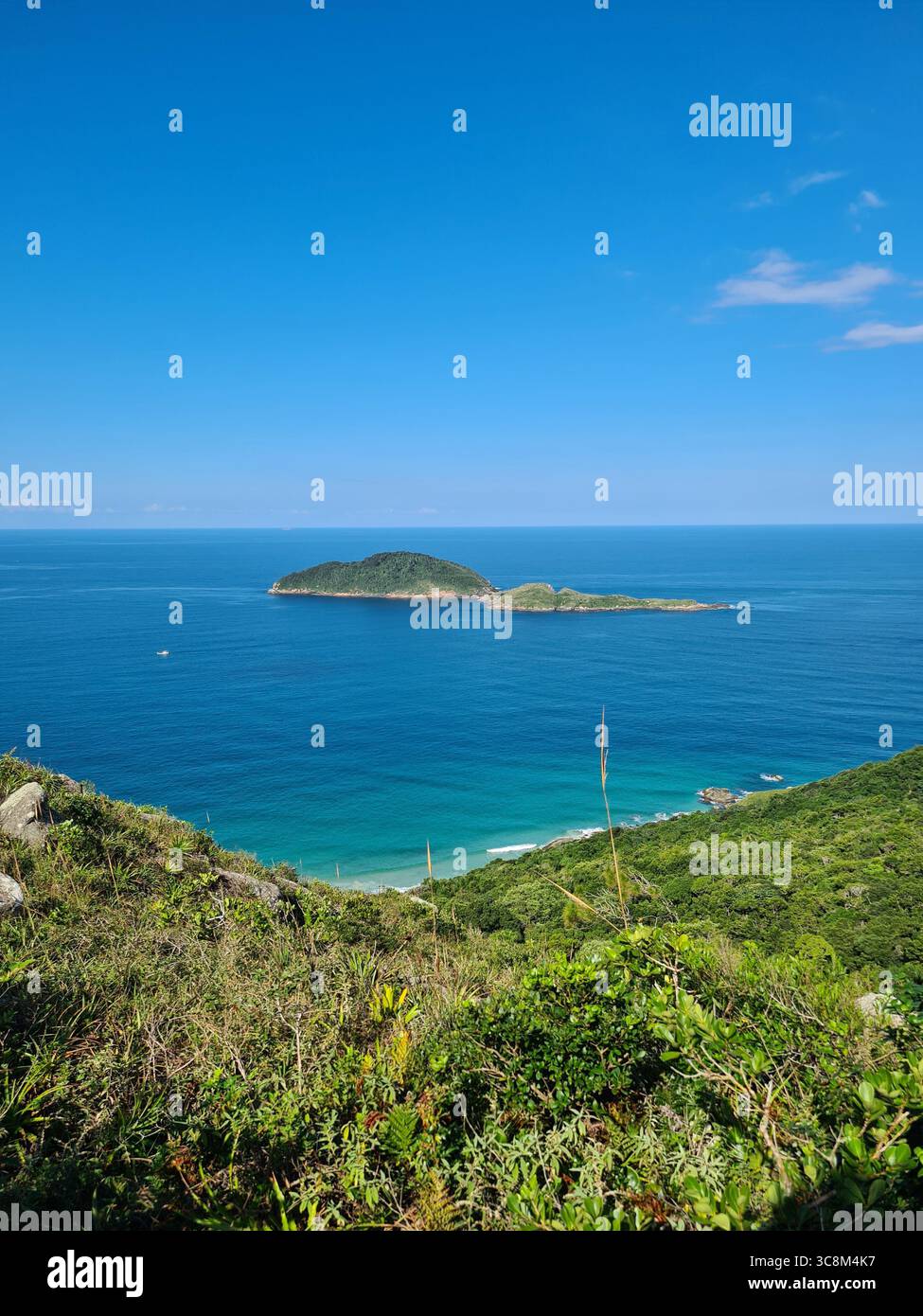 View of Spider Island in Florianópolis, Santa Catarina, Brazil, on a beautiful sunny day with a blue sky - Smartphone Captured Stock Image