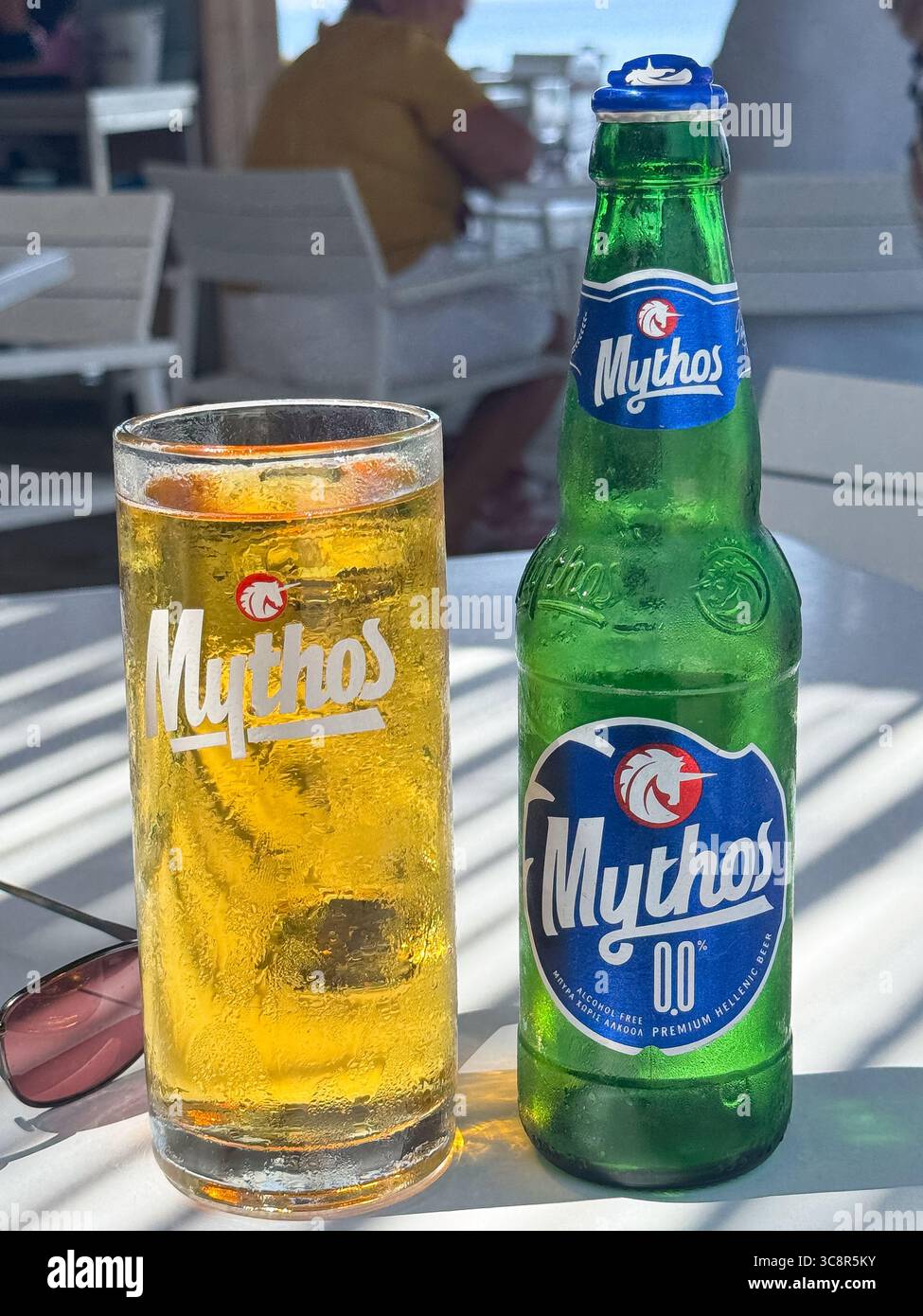 Pefkos, Rhodes, Greece; A bottle and glass of Mythos beer Stock Photo