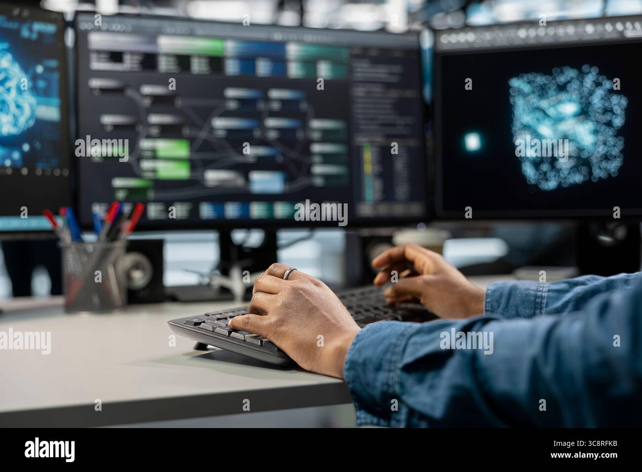 Close up of data center professional using machine learning algorithms to analyze large datasets. Server farm engineer typing on keyboard, using artificial intelligence to recognize data patterns Stock Photo
