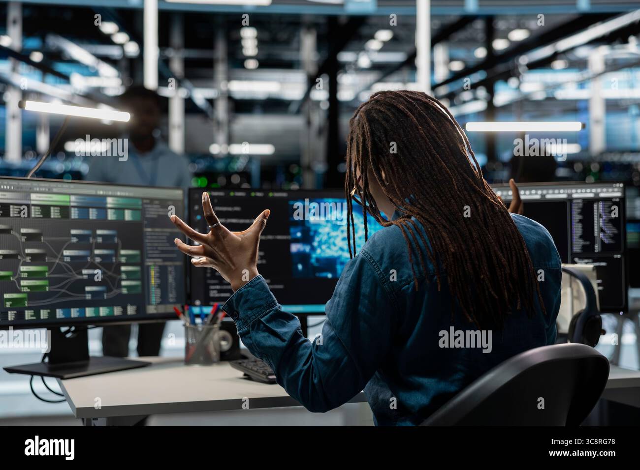 Disgruntled server room worker raging, irked by bugs while using AI tools. Mad programmer fed up with broken data center equipment needed to run artificial intelligence and machine learning Stock Photo